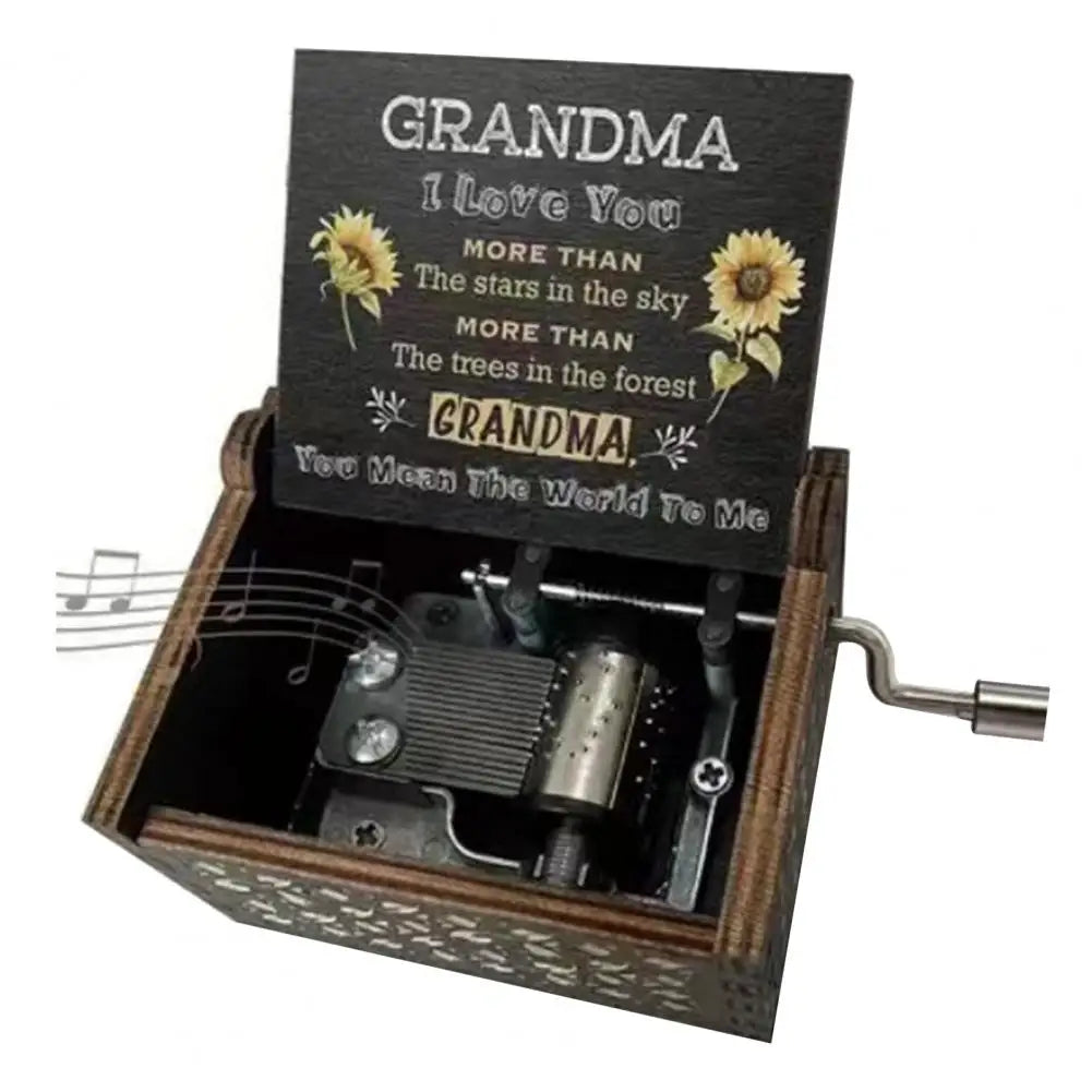 A small wooden music box with a label that reads Grandma I love you more than the stars in the sky and the trees in the fores