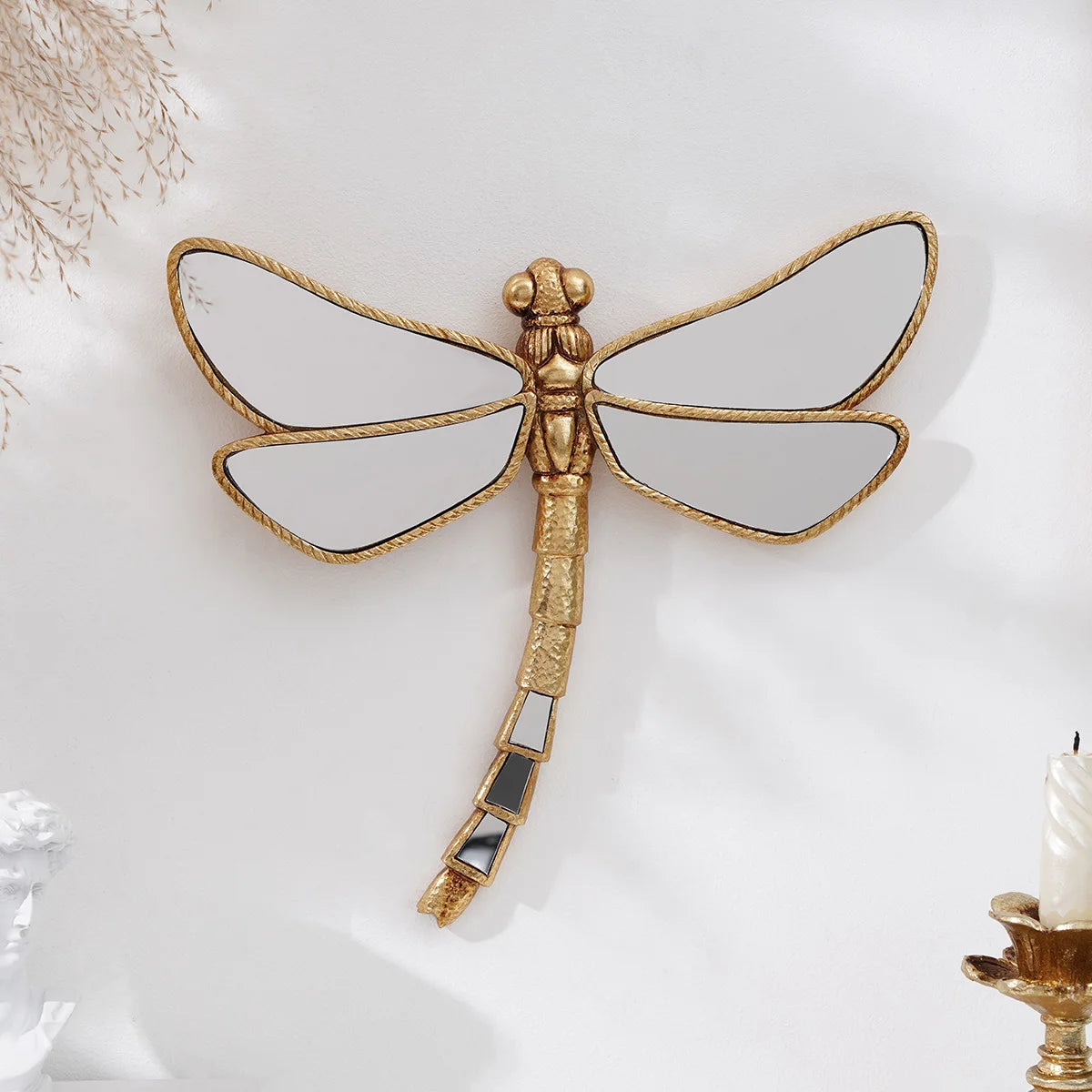 Golden dragonfly mirror wall decor featuring a detailed, gilded insect with translucent wings and an elongated body.