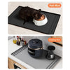 A black silicone mat is shown with a cat eating on it, and a gray silicone cooking mat is shown with a pot on it.