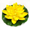 A bright yellow artificial lotus flower blooming on a green leaf.