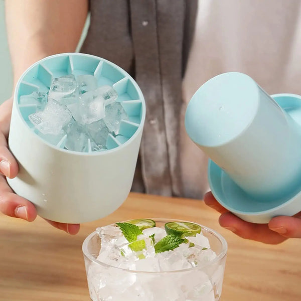 A hand holds a silicone ice cube mold set with blue ice cubes and a light blue cup.
