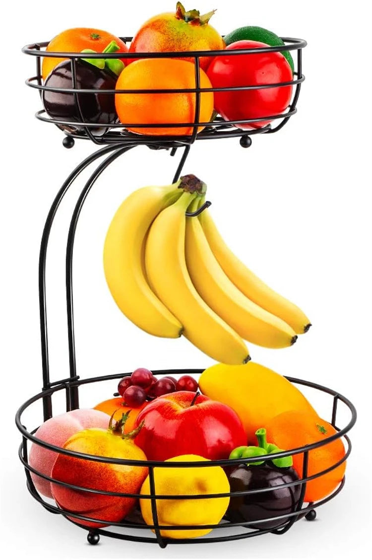 A two-tier metal fruit basket organizer filled with various colorful fruits including oranges, apples, and bananas.