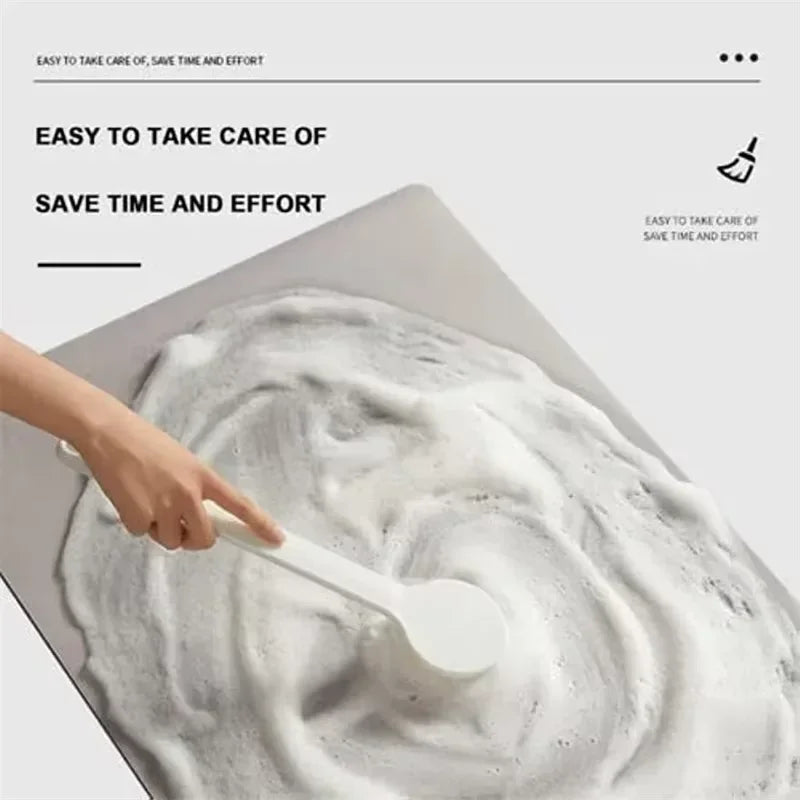 A hand is using a white spoon to scoop foam from a white mat, demonstrating easy care and saving time.