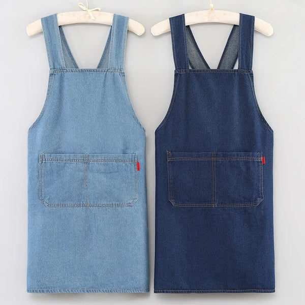A pair of denim aprons, one light blue and one dark blue, displayed on hangers.