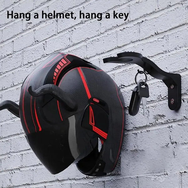 A black helmet is hanging on a black wall hook, with text reading Hang a helmet, hang a key.