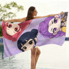 A woman holds up a glitter purple chibi anime beach towel featuring multiple characters.