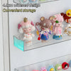 A clear acrylic display shelf holds several cute, pink and brown collectible figures.