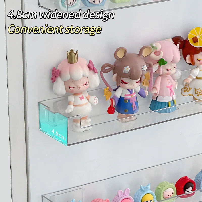 A clear acrylic display shelf holds several cute, pink and brown collectible figures.