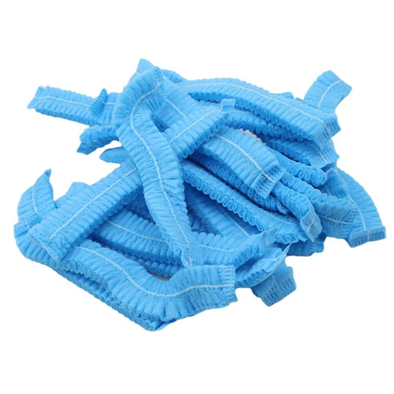 A pile of light blue disposable microblading hair net caps for permanent makeup.