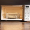 A clear microwave splatter guard with a heat-resistant handle is shown inside a beige appliance.