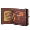 A brown leather photo album with a cover featuring a globe design and the text Our Adventure Book