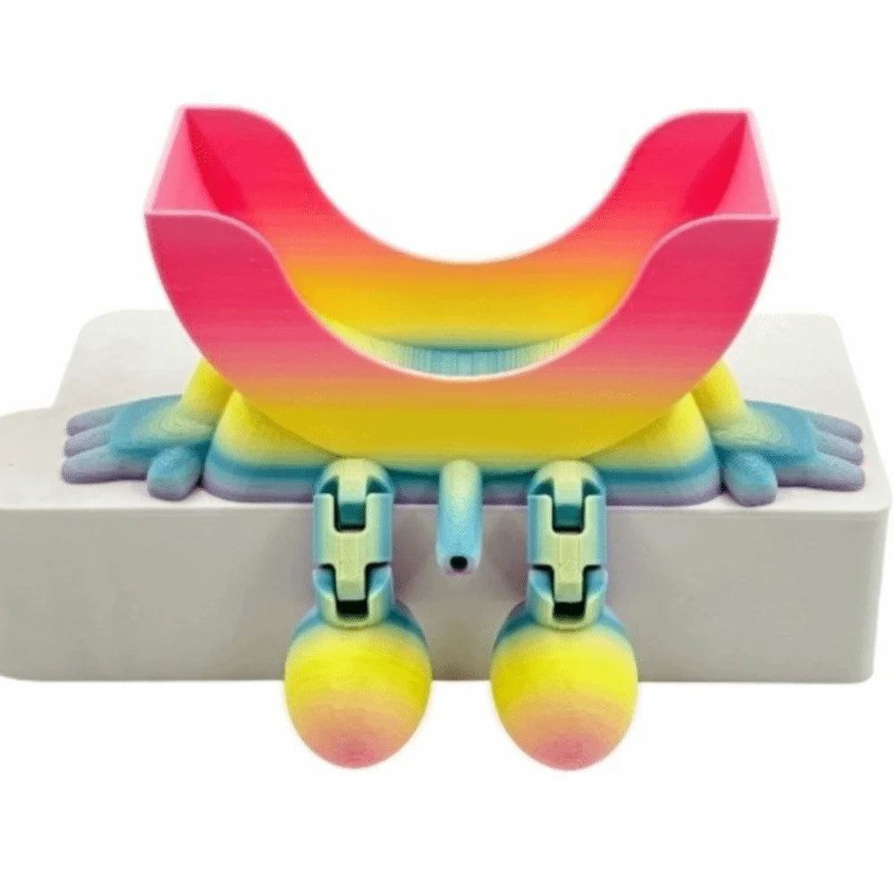 A colorful, multi-use sponge holder with a pink and yellow curved design sits on a white surface.