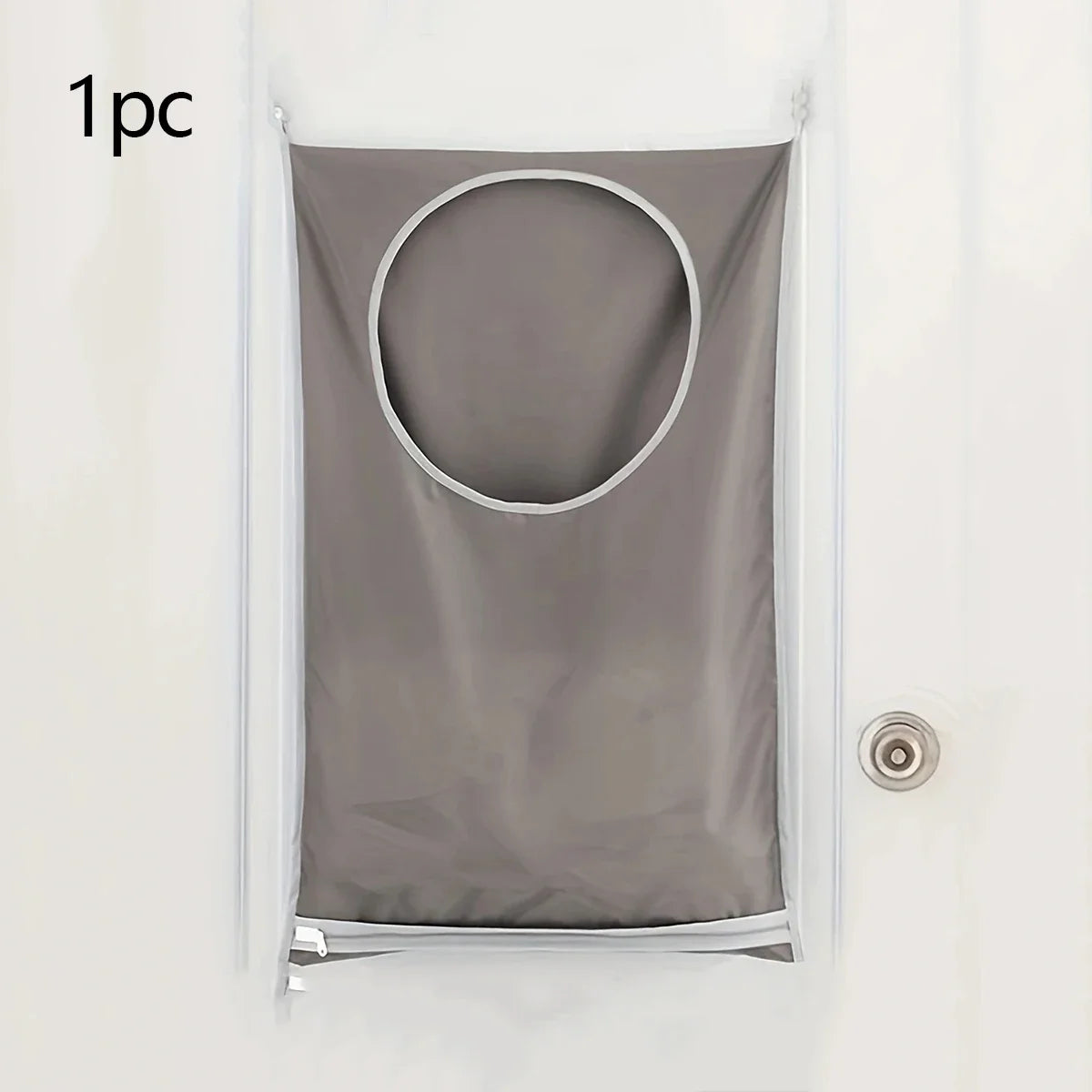 A gray fabric laundry organizer hanging on a white door.